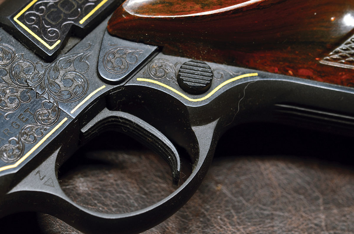 The second series Woodsman adopted a Colt 1911-style button release for the magazine, replacing the original, which was on the heel of the grip.  Unfortunately, the thumb rest of the grip gets in the way of operating it conveniently for quick magazine changes. In the later series-three guns, the release was returned to  its original position.